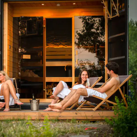 Guests outside a Pixxla sauna in nature.