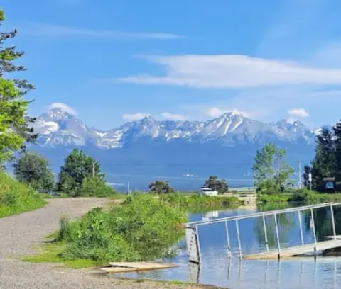 View of the High Tatras and the water beside Poprad Sauna in Kvetnica.