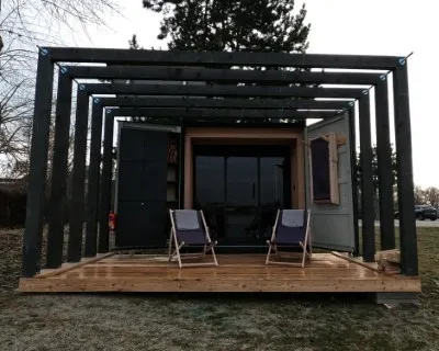Wooden terrace with two deck chairs in front of the Pixxla sauna at Sunny Lakes.